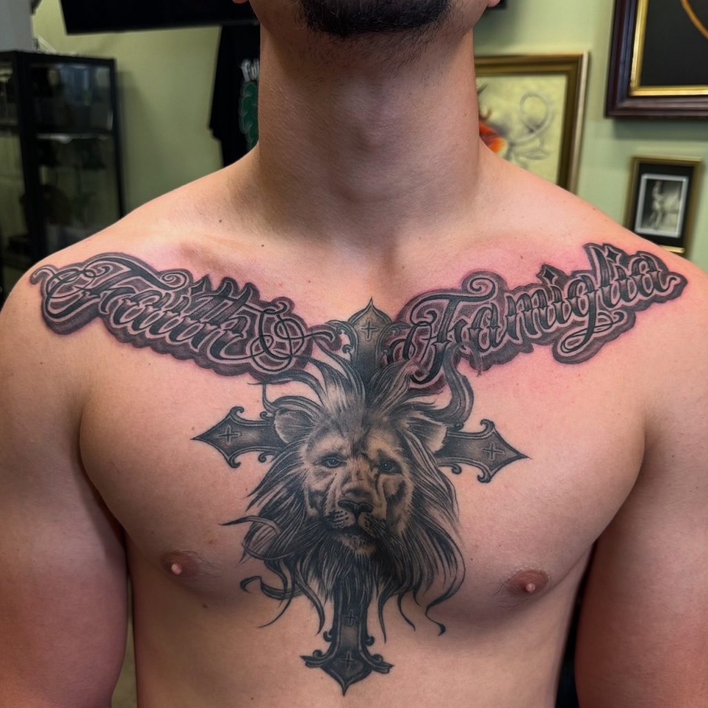 Ornate script and lion head tattoo across the chest.